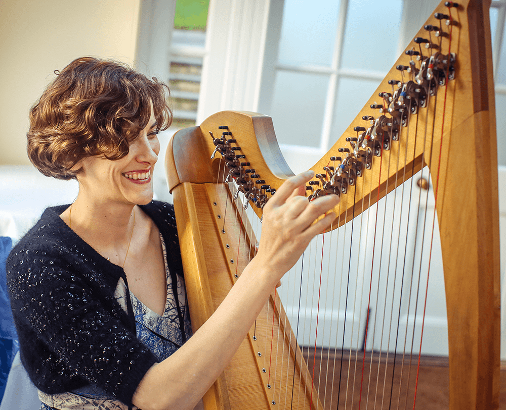 Steph West holding a harp