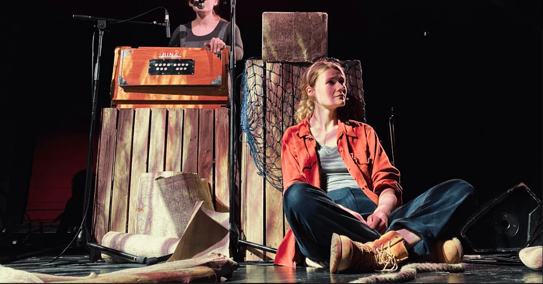 Isobel Hughes sitting against boxes