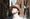 Side profile of Paul Smith wearing a cream sun hat looking up to the sky with his eyes closed.