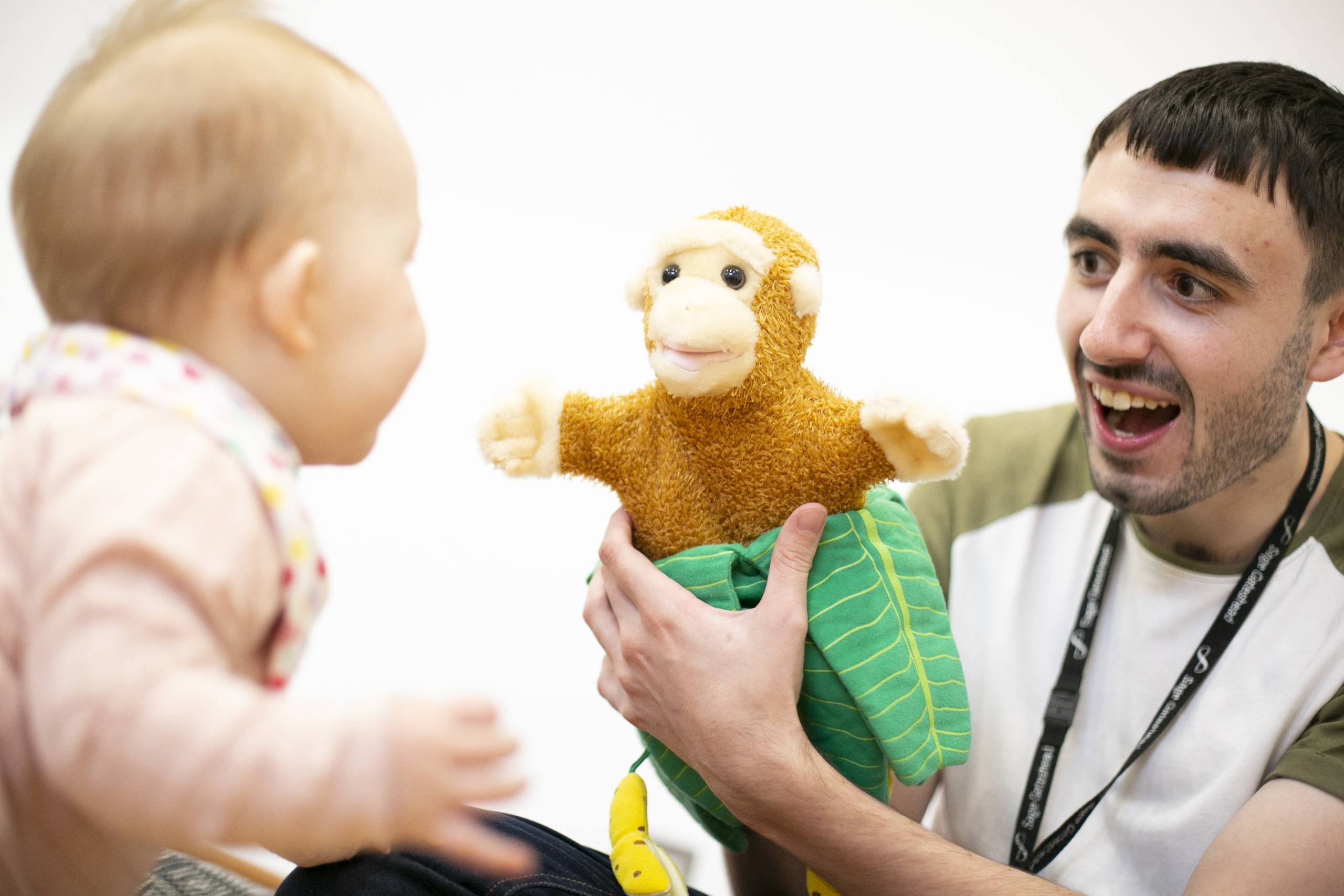 person with brown hair and a monkey puppet with a blonde baby