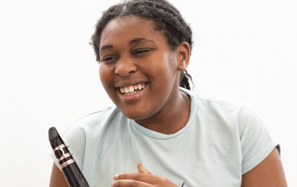 Young musician with a clarinet and green top