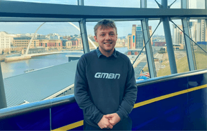 person in blue jumper in glass building