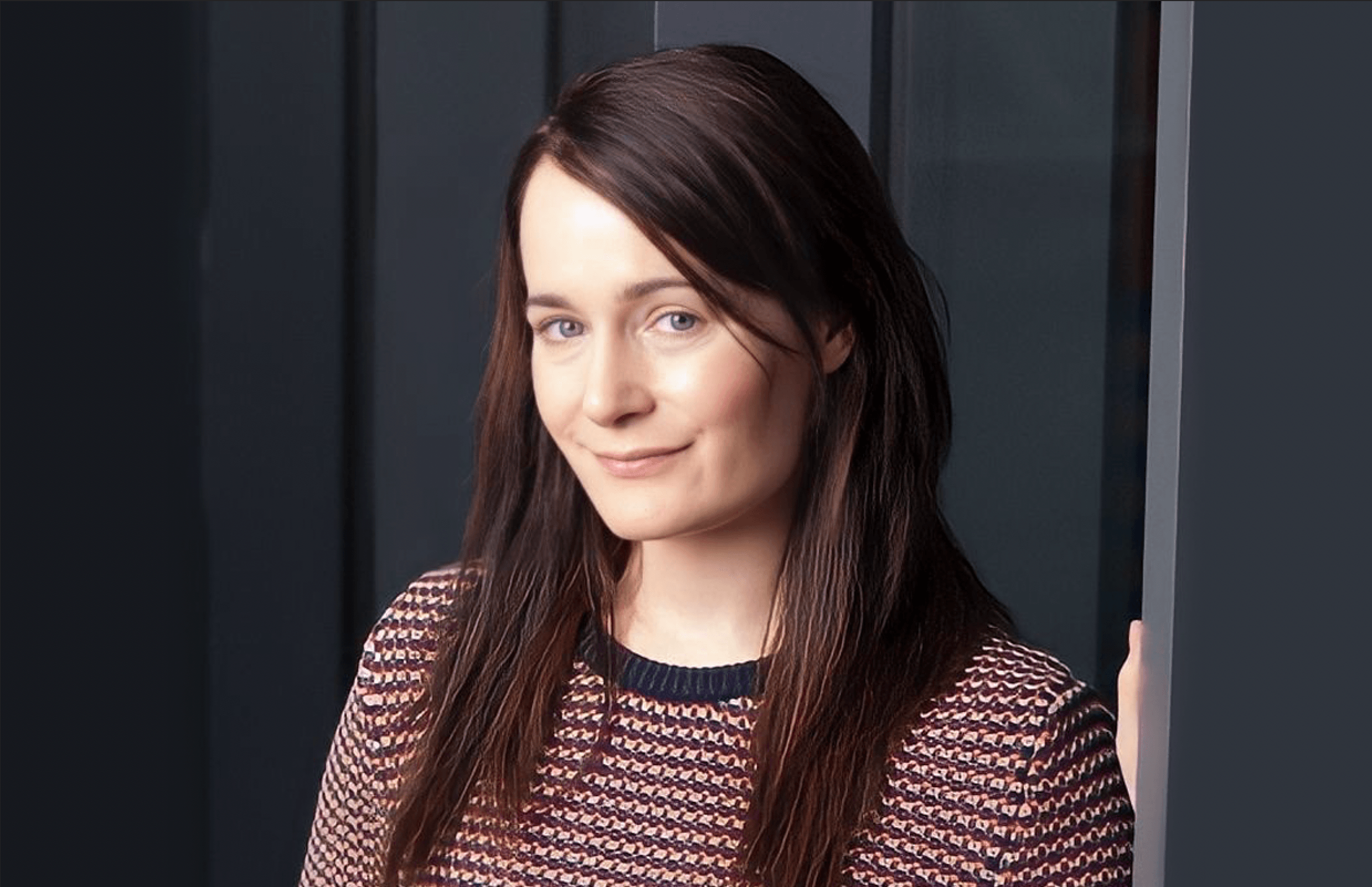 person with brown hair and a brown stripe top