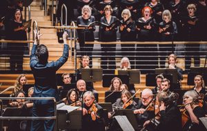 Dinis conducting musicians on stage for A Child of Our Time