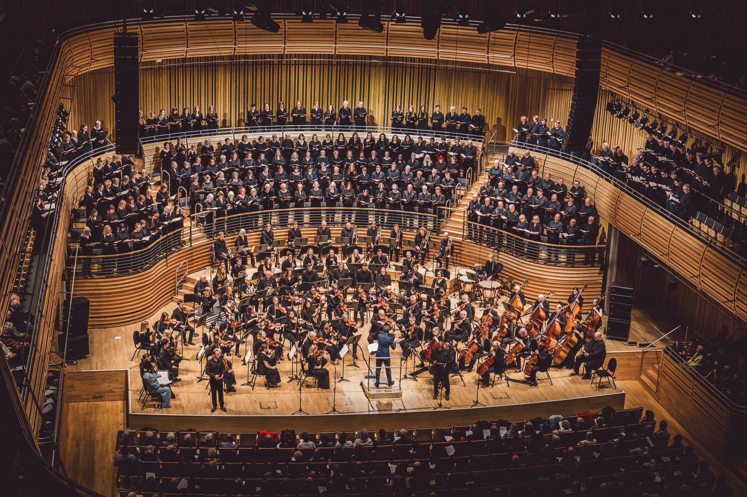 The stage full of musicians wearing black for Share the Stage