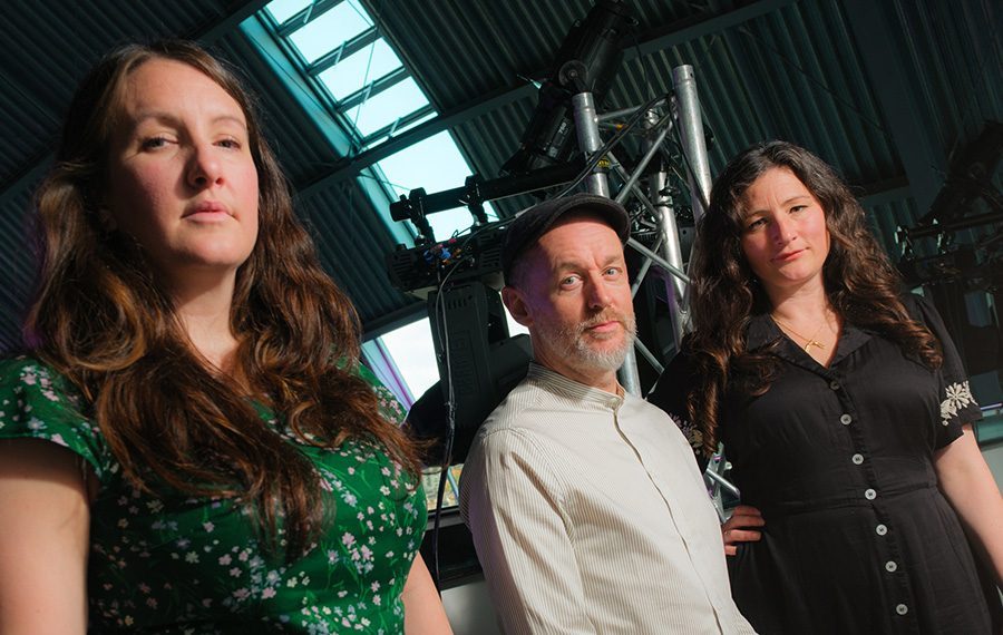The Unthanks standing in front of equipment.