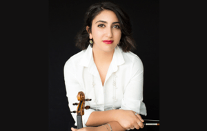 Eva Aronian in a white shirt holding her violin.