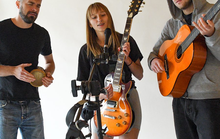 a group of young people play music on musical instruments. a you
