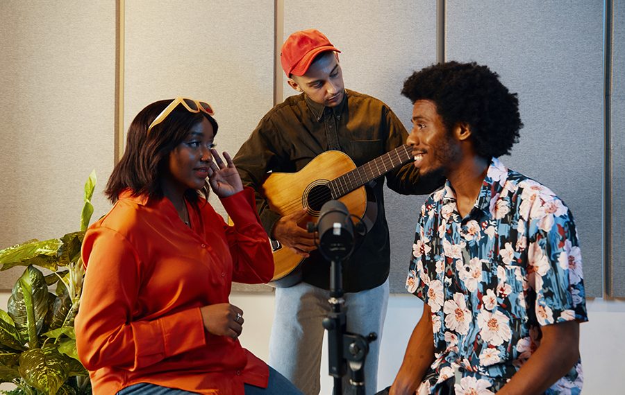 Music group rehearsing together in recording studio