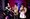 Three musicians playing trumpet and trombone together on stage.