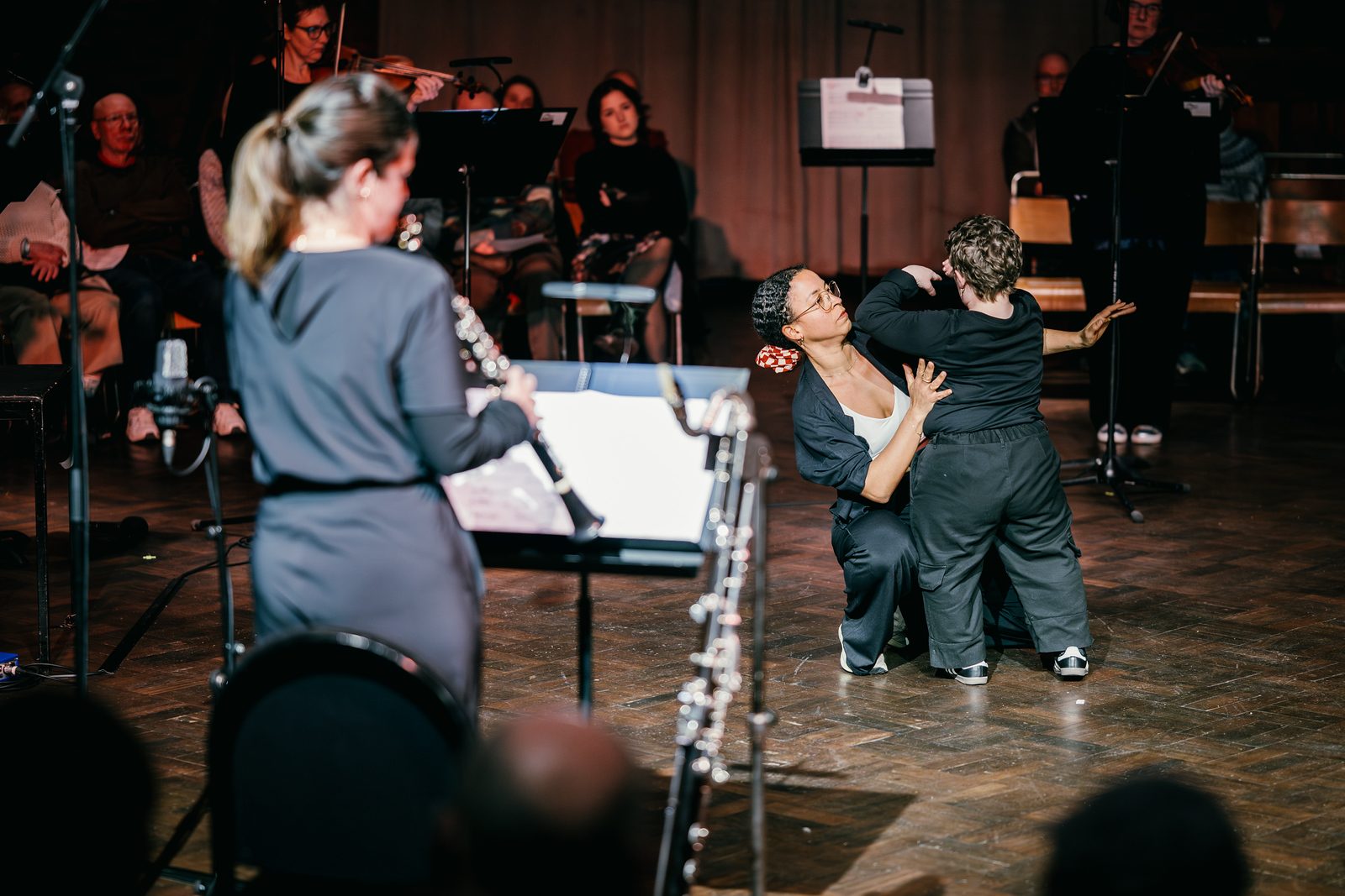 Performers dancing together on stage, surrounded by RNS Moves.