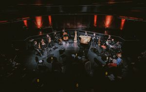RNS Moves performing in the round, surrounded by an audience.