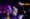Microphone on stage, with a blurred purple lit background
